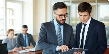 Business professionals reviewing documents in a meeting room