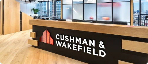 Cushman & Wakefield office reception desk with company logo.